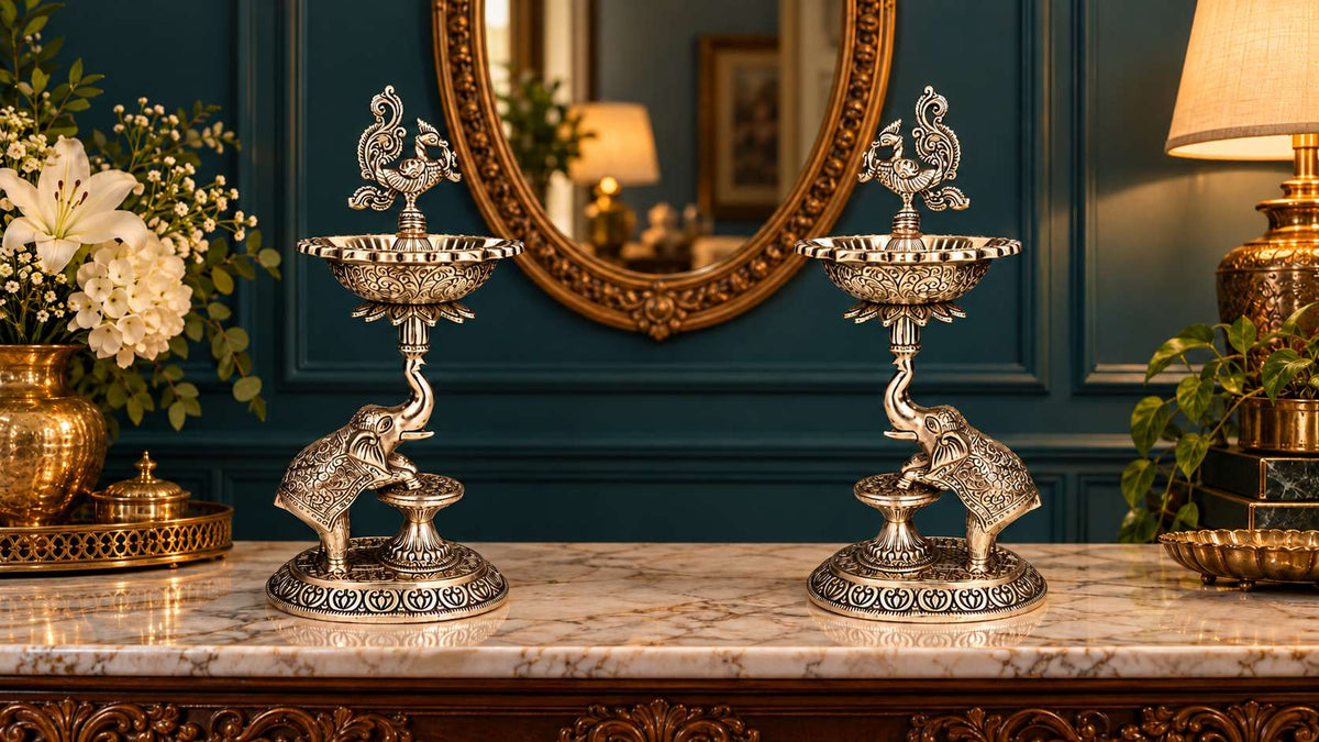 Plain German silver peacock elephant samai lamp pair in a teal living room, mirrored facing each other