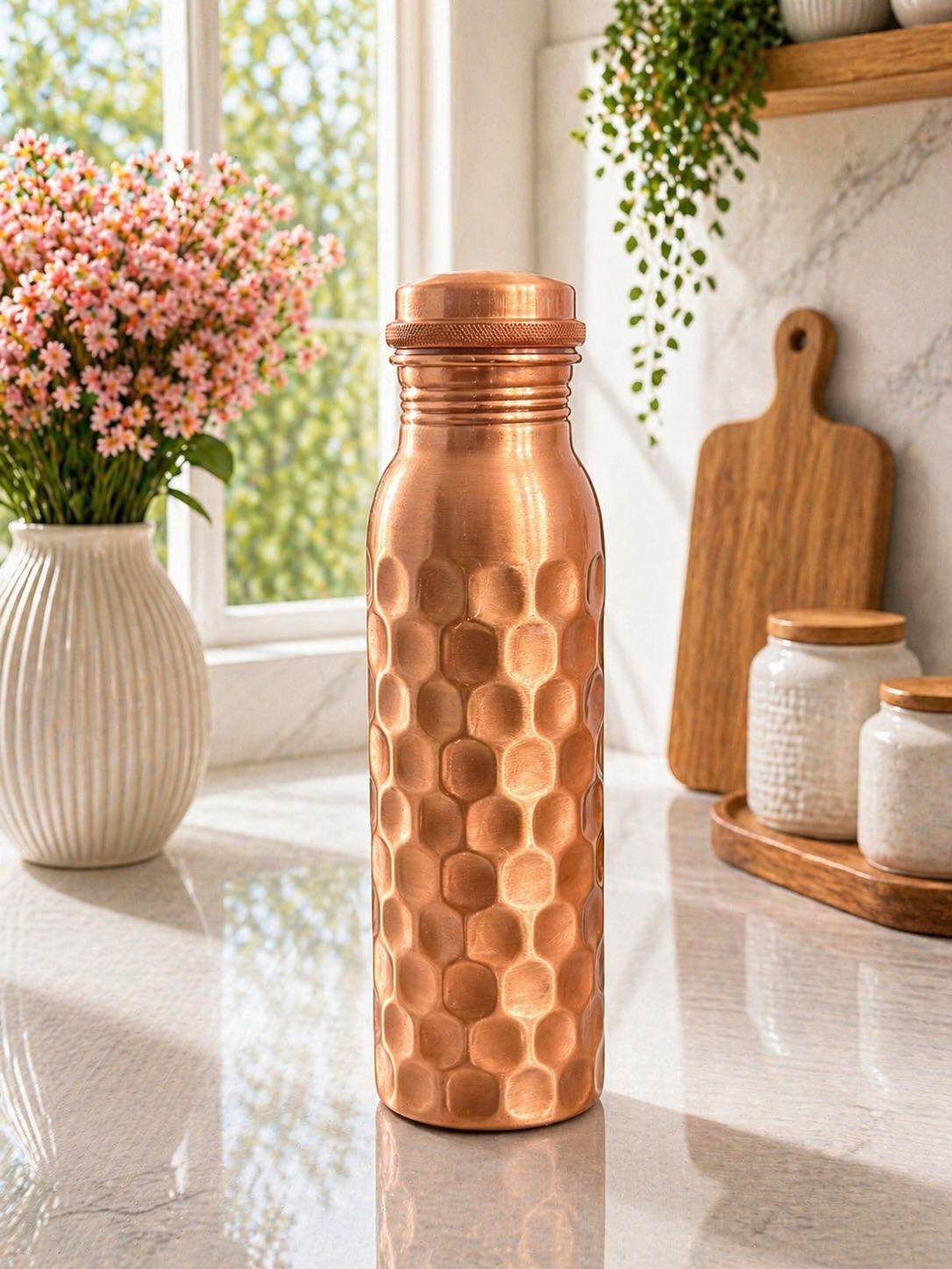 Pure Copper Water Bottle 900ml Hammered honeycomb texture bottle in a bright kitchen