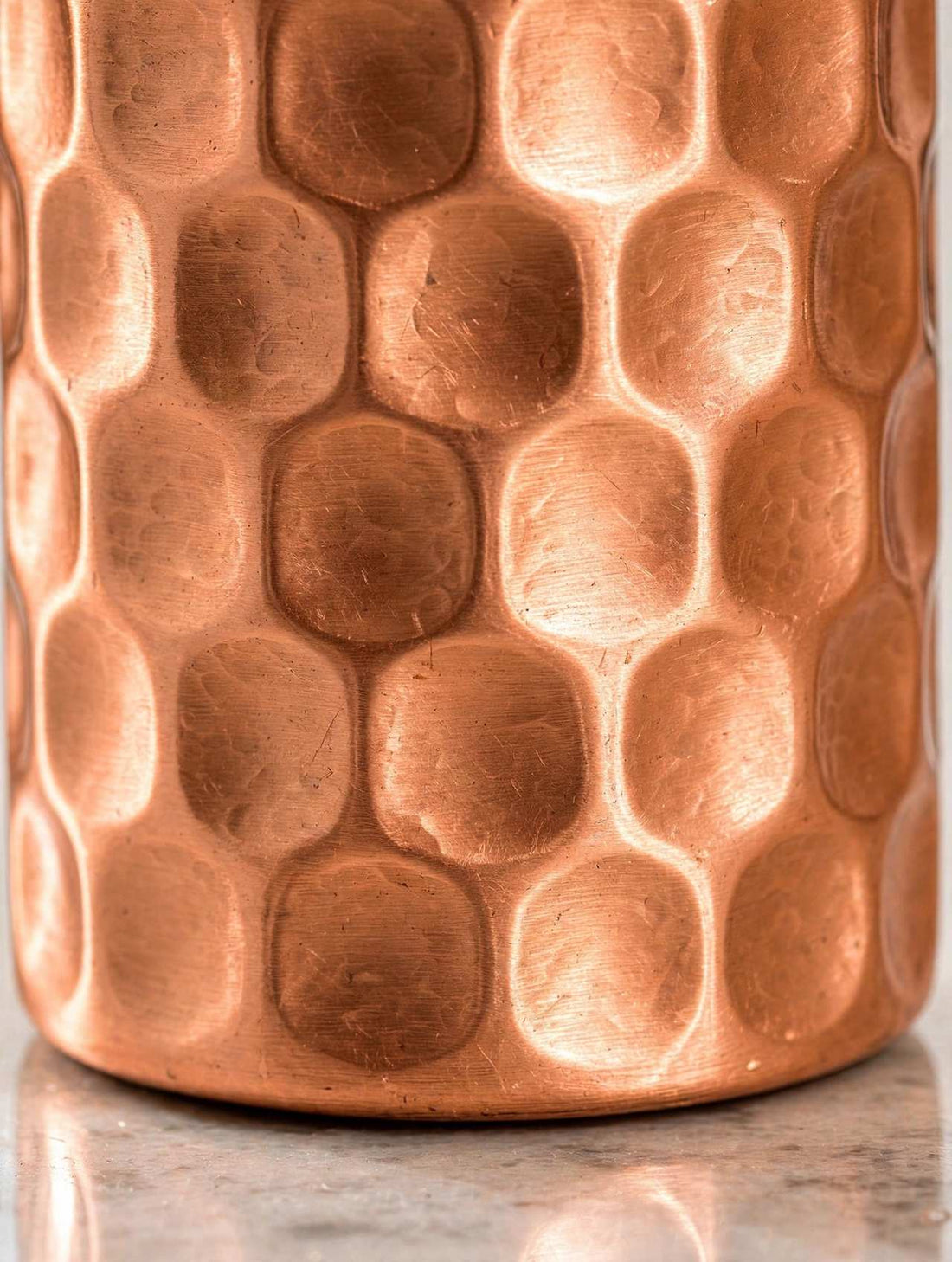 Pure Copper Water Bottle 900ml Hammered honeycomb texture bottle in a bright kitchen