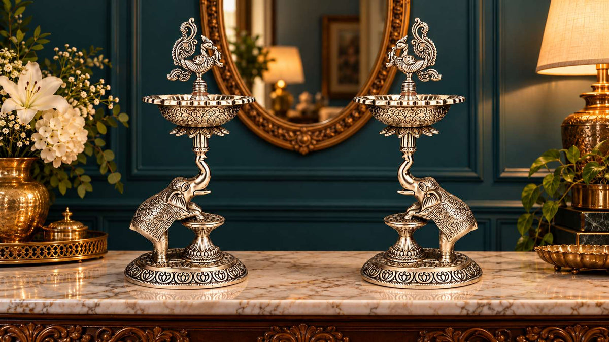 Pair of 13 inch plain German silver elephant samai lamps with peacock finials, full front view