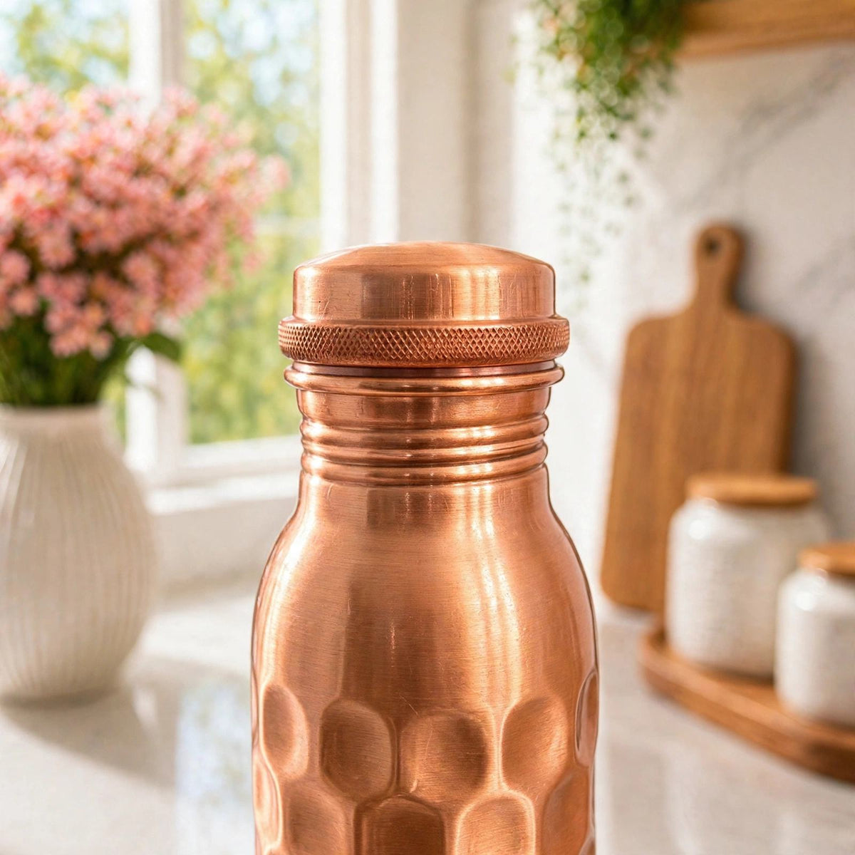 Close-up of the short squat copper cap and neck of the hammered copper bottle