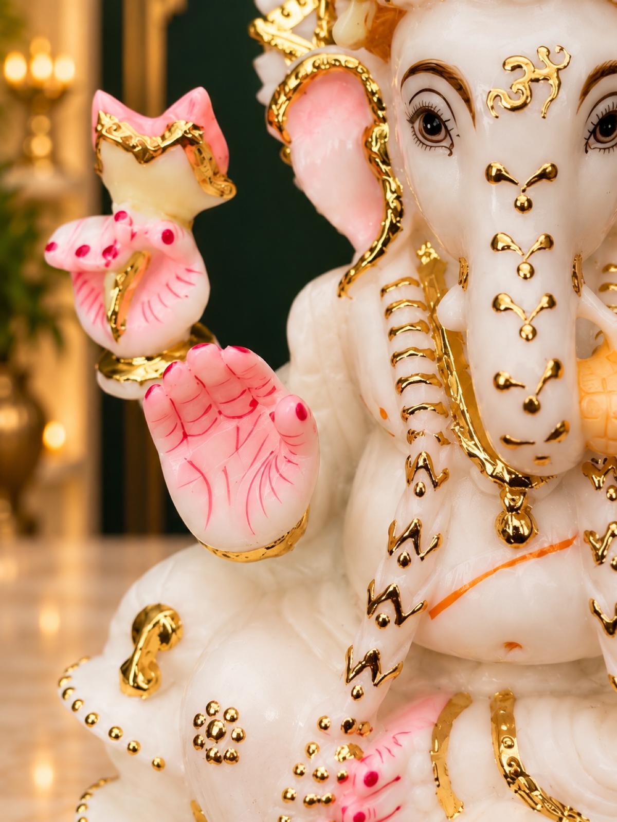 Close-up of Ganesha blessing hand and trunk with gold Om symbol