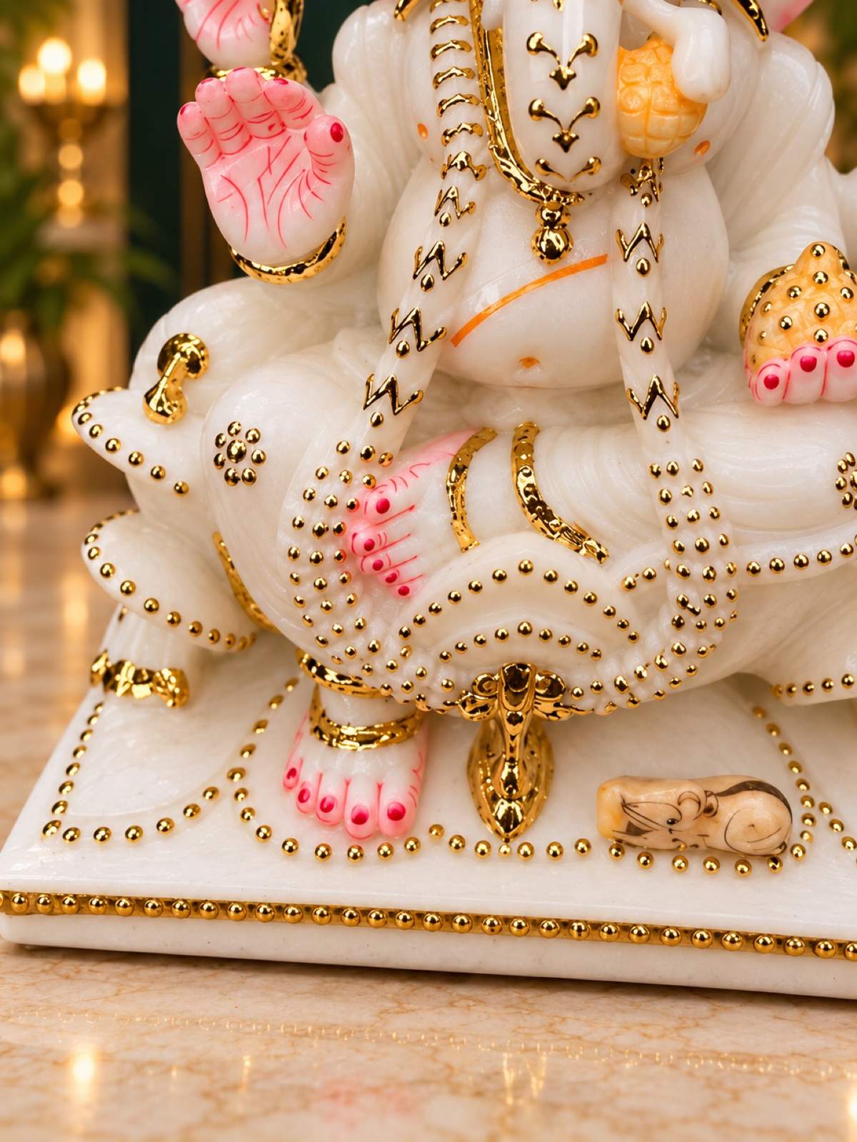 Close-up of Ganesha base with gold beading and mouse vahana