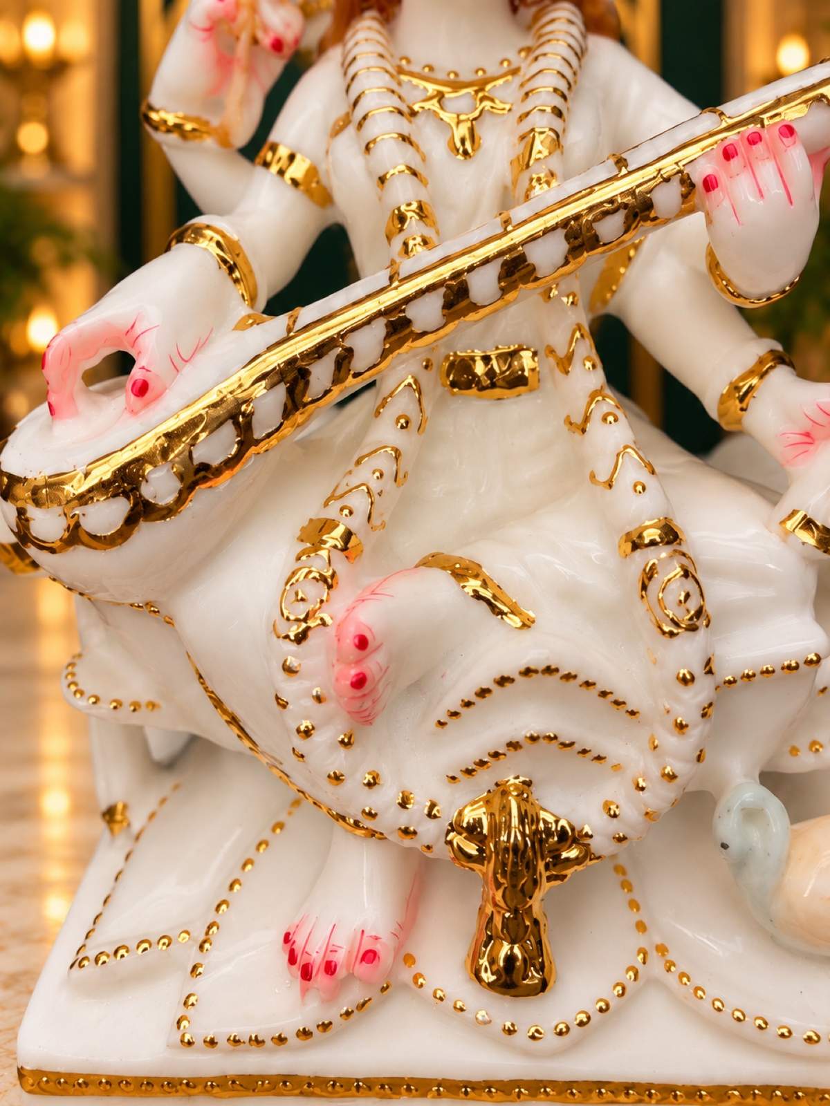 Close-up of Saraswati veena with cut gold detailing