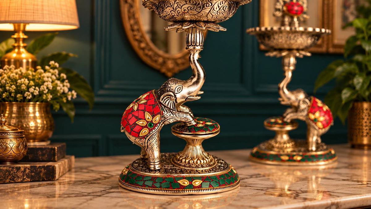 Close-up of elephant with red stonework saddle blanket and green stonework base