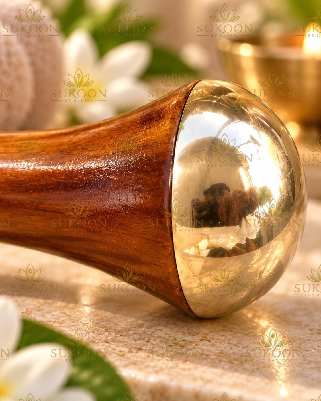 Kansa face massage wand on marble pedestal