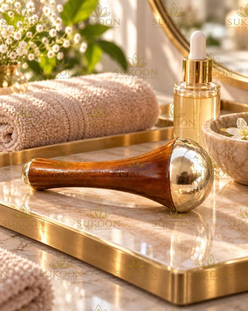 Pure kansa face massage wand with teak wood handle on marble tray