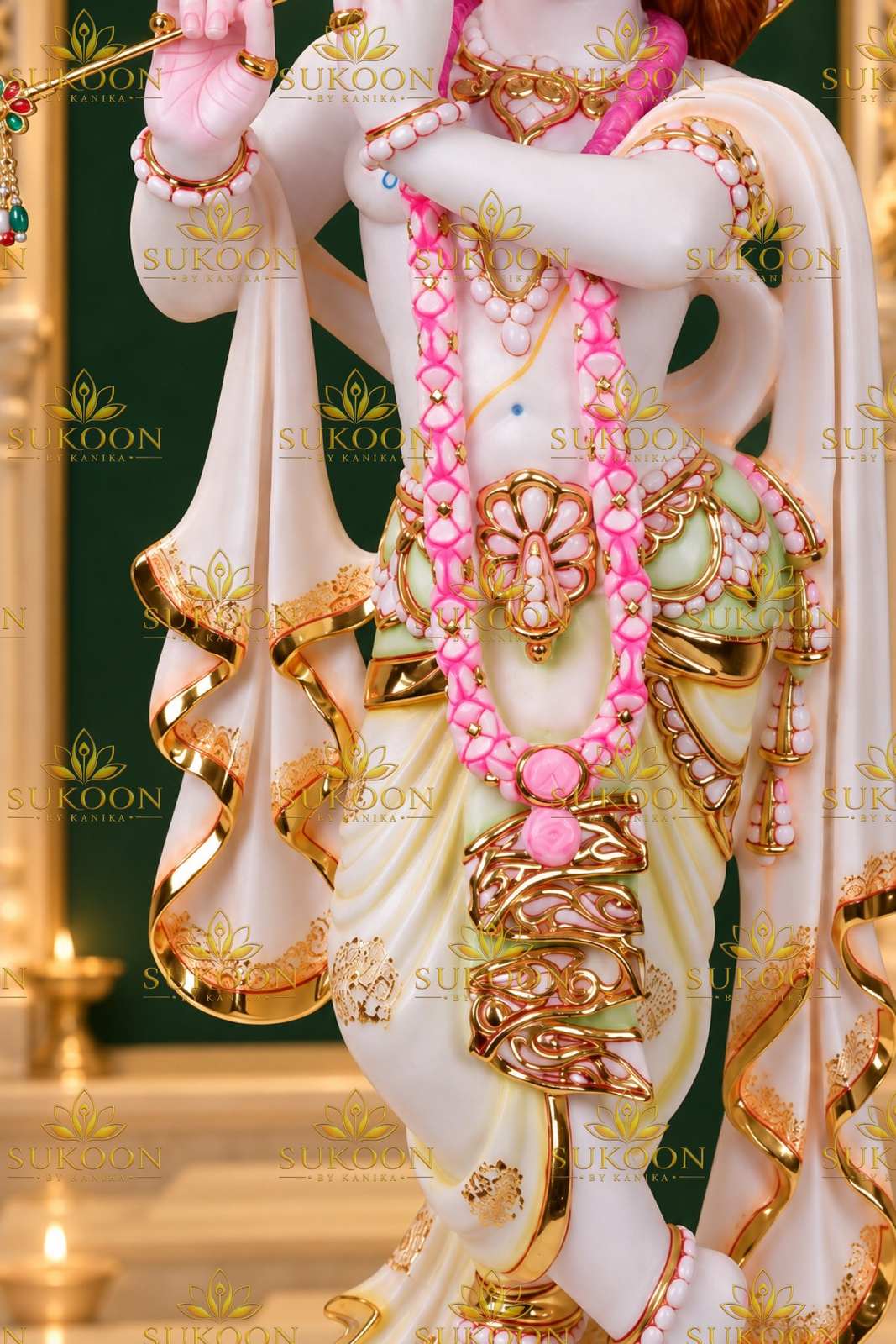 Krishna statue mid-body detail gold dhoti pink garland marble idol